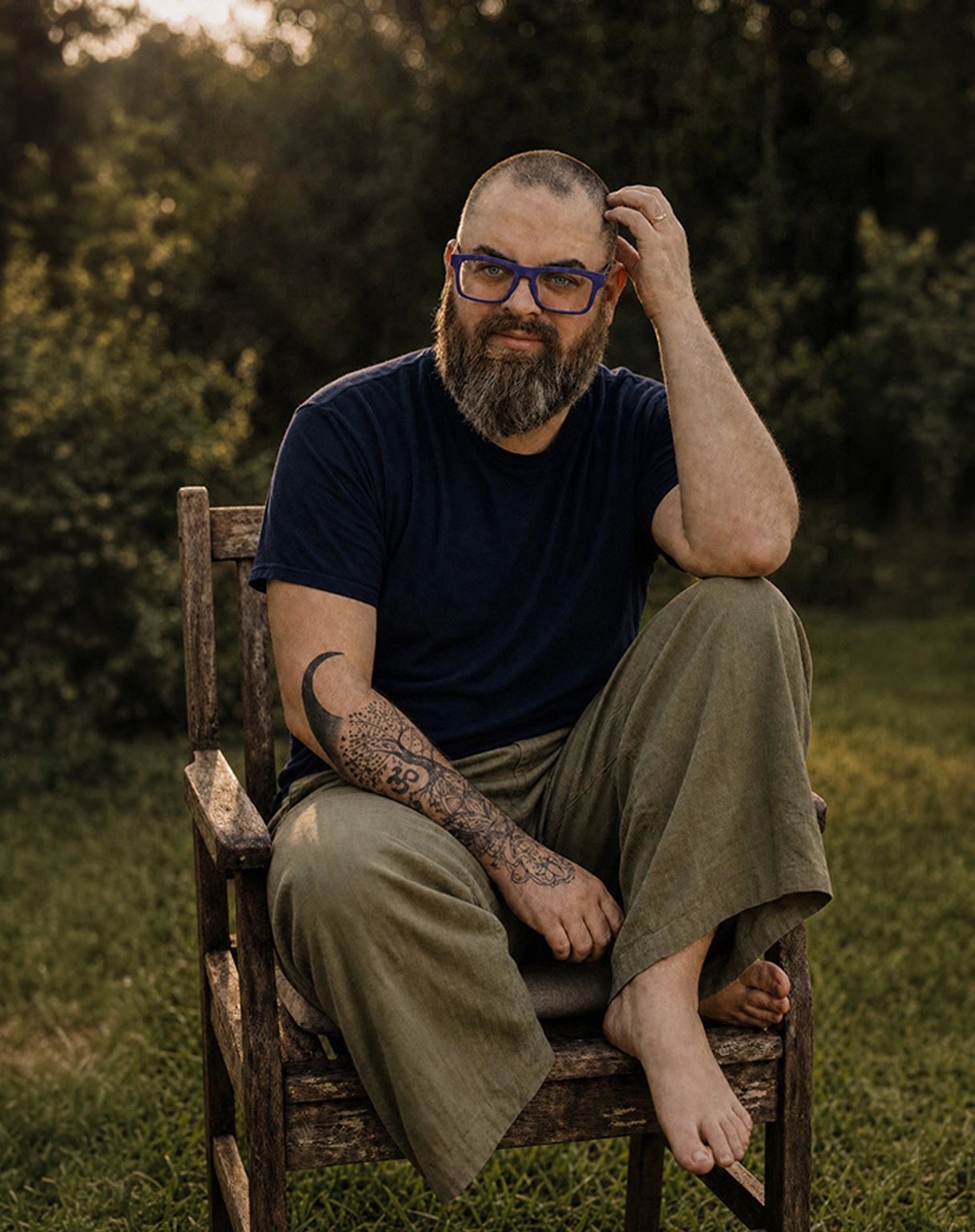 Matt Hankerson, founder of Sacred Identity Studio, in a candlelit study